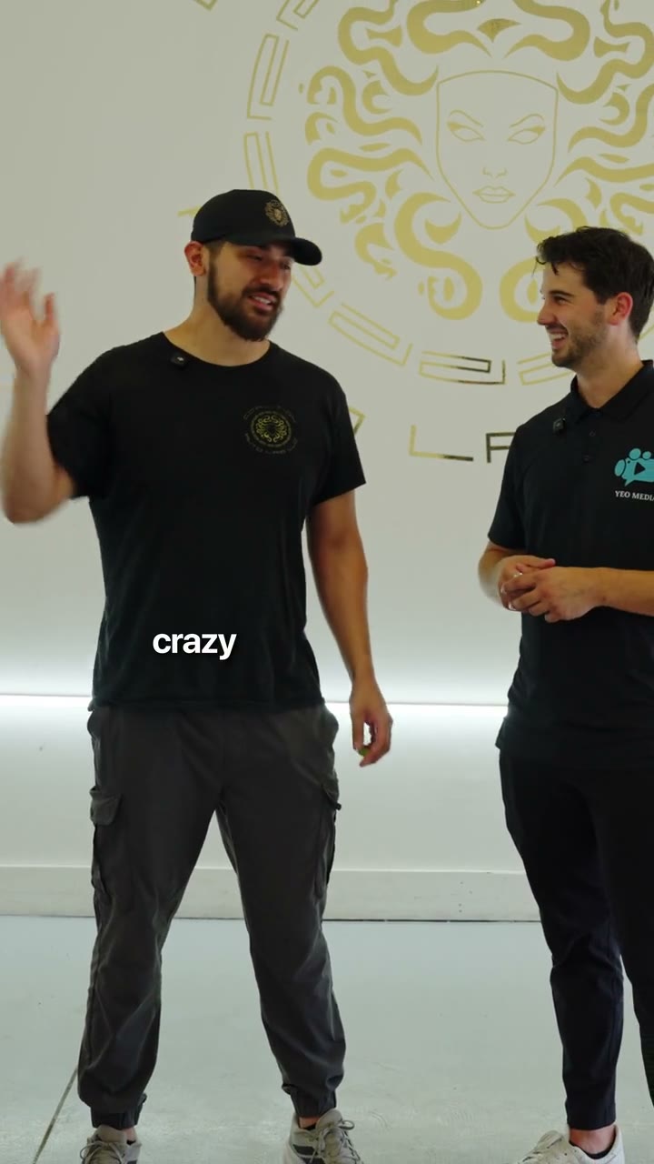 Video still: the owner of Coalition Autolab talking with Parker Yeo in the shop, under the Coalition logo, captioned crazy.