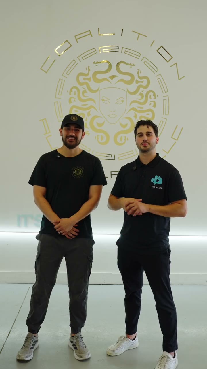Video still: Parker Yeo and the owner of Coalition Autolab standing together in the shop under the Coalition logo.