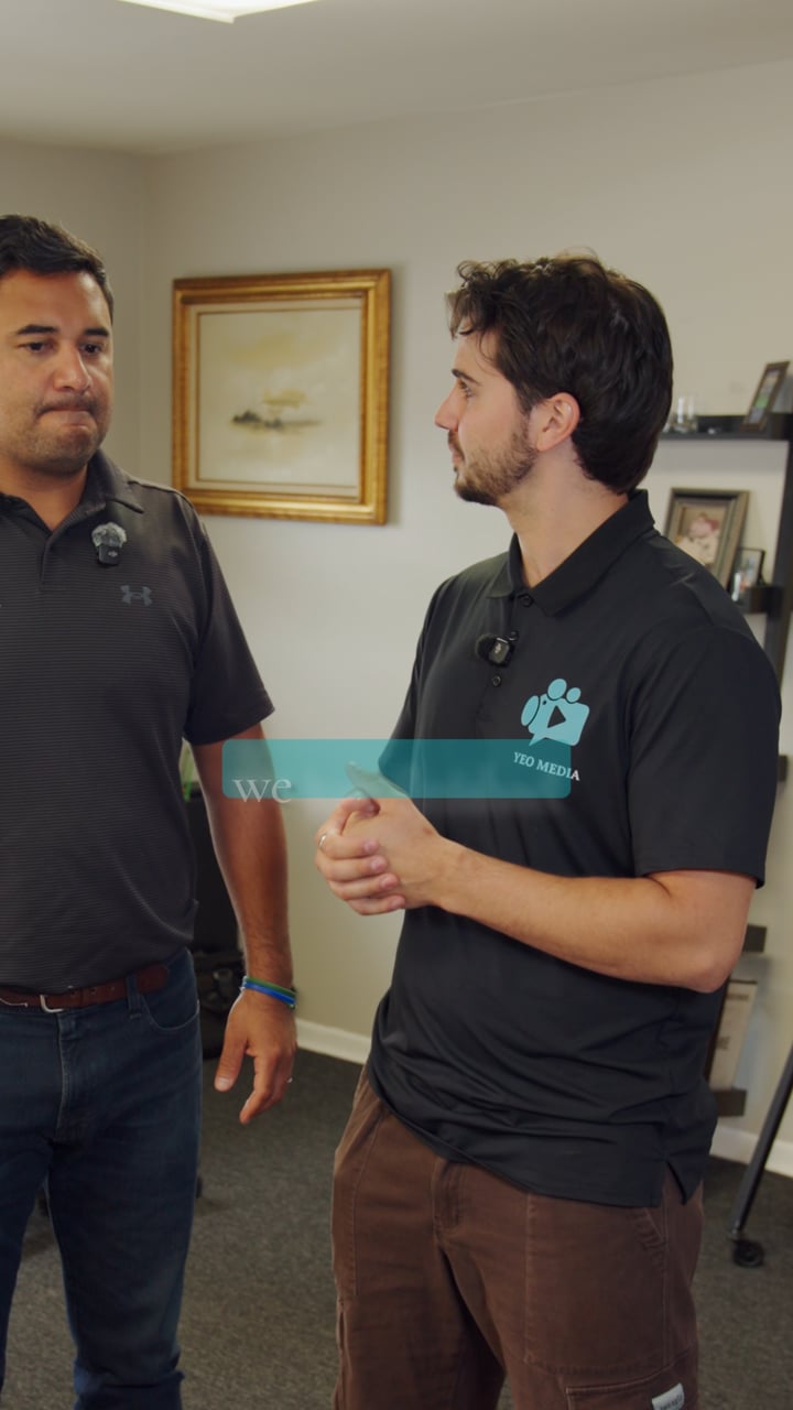 Reel still: Parker Yeo in a Yeo Media polo interviewing the owner of Robacks Truck and Auto in his office, with a caption starting to appear on screen.
